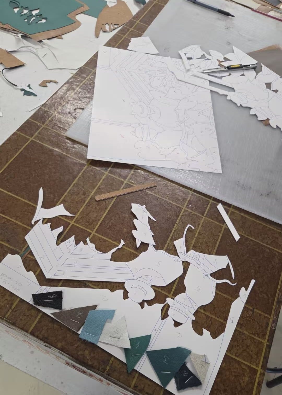 Marquetry patterns and templates on the Spirit of Artisans workbench.